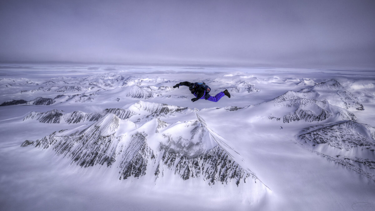 A skydiver free falls over Union Glacier