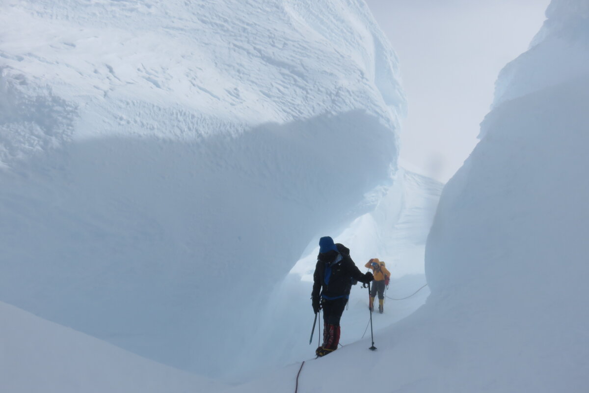 Climbers navigate through enormous snow mushrooms
